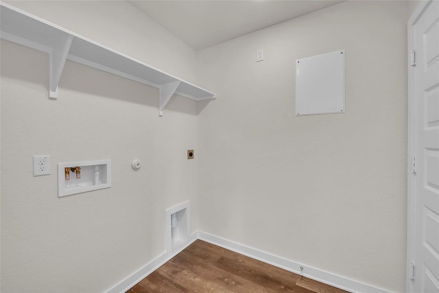 Laundry room with hookup for a gas dryer, dark wood finished floors, hookup for a washing machine, and hookup for an electric dryer Laundry room with hookup for a gas dryer, dark wood finished floors, hookup for a washing machine, and hookup for an electric dryer