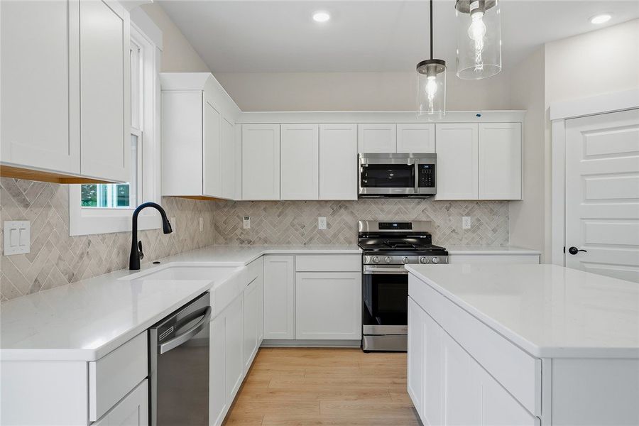 Gleaming stone countertops and a modern herringbon