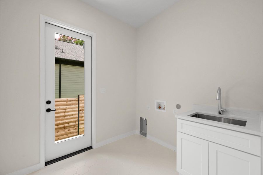 A dedicated laundry space boasts a practical sink, ready for all household needs. A dedicated laundry space boasts a practical sink, ready for all household needs.