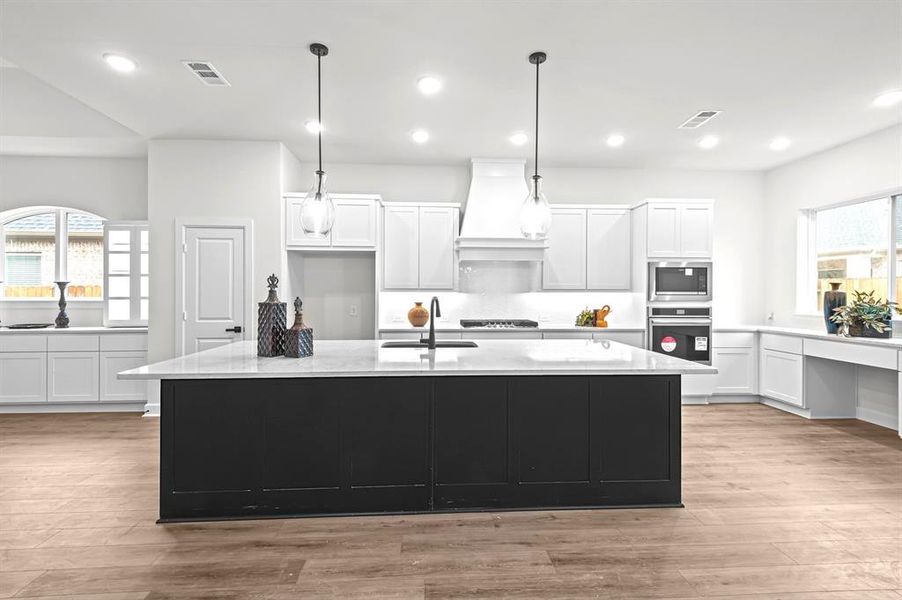 Gorgeous Kitchen with huge island, quartz counters, and command center/desk area.