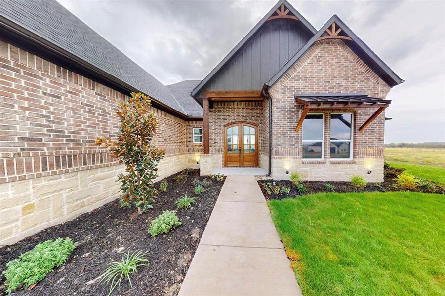 View of front of property featuring french doors and a front yard