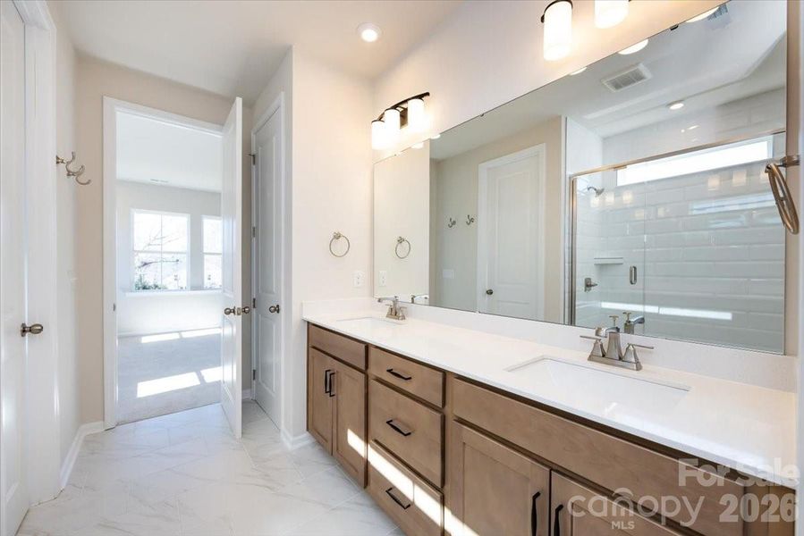 Dual Vanity Primary Bathroom with Warm Brown Cabinets Dual Vanity Primary Bathroom with Warm Brown Cabinets