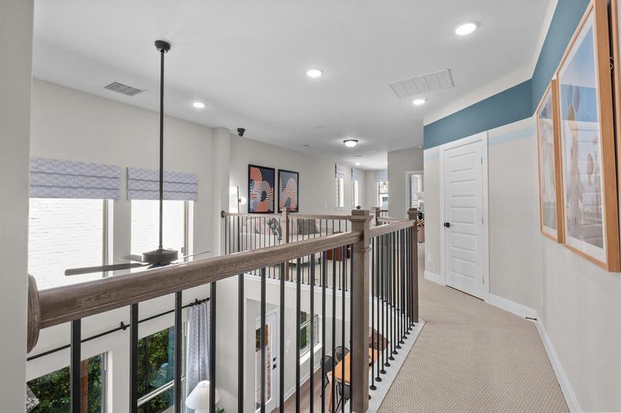 Corridor featuring light colored carpet and recessed lighting