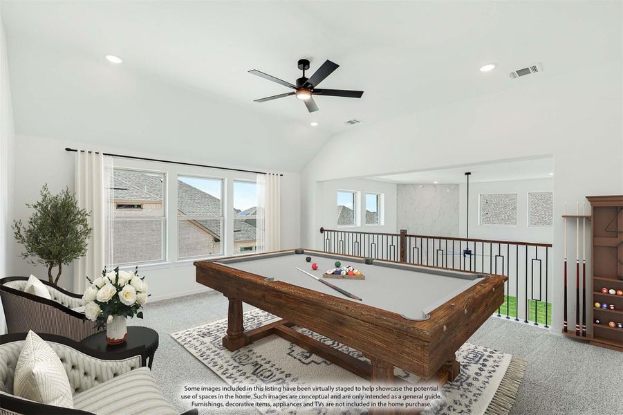 Game room with wood pool table, vaulted ceiling, ceiling fan, and open loft railing overlooking lower level. Game room with wood pool table, vaulted ceiling, ceiling fan, and open loft railing overlooking lower level.