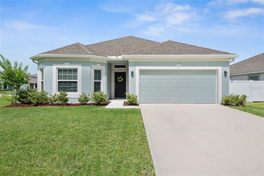Front exterior of a new home in Sawmill Creek at Palm Coast Park, Palm Coast, FL, highlighting curb appeal (Image 26). Front exterior of a new home in Sawmill Creek at Palm Coast Park, Palm Coast, FL, highlighting curb appeal (Image 26).