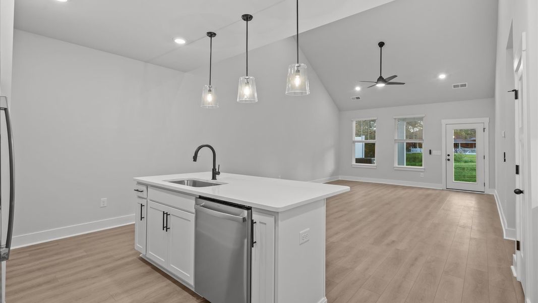Accomplished kitchen design featuring pendant lighting above a statement island for both prep and gathering Accomplished kitchen design featuring pendant lighting above a statement island for both prep and gathering