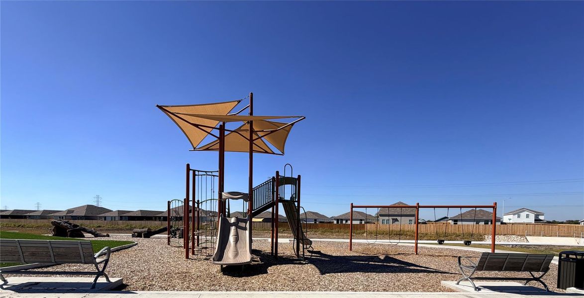 Community play area featuring a residential view Community play area featuring a residential view