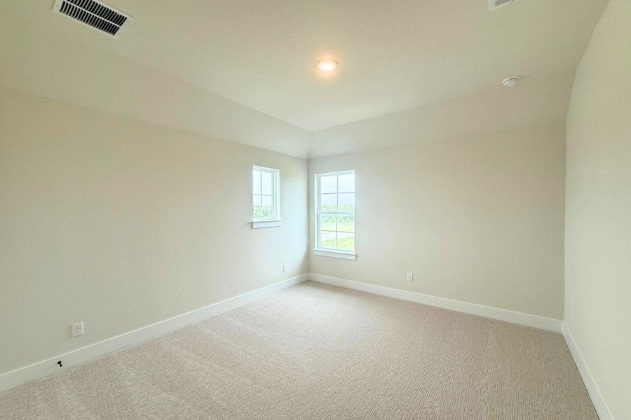 A quiet bedroom offering wall-to-wall carpeting and ample natural light from two windows. A quiet bedroom offering wall-to-wall carpeting and ample natural light from two windows.