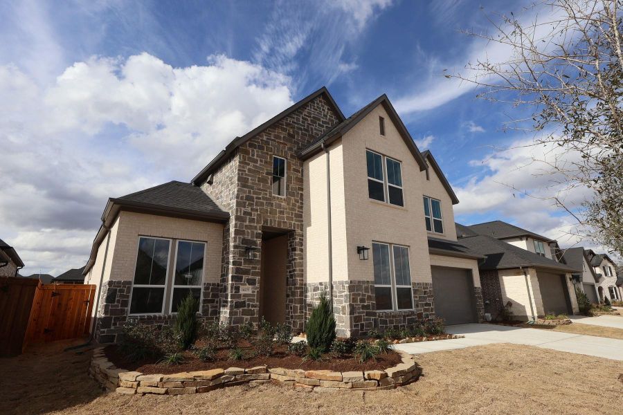 Front exterior of a new home in Dunham Pointe, Cypress, TX, highlighting curb appeal (Image 19). Front exterior of a new home in Dunham Pointe, Cypress, TX, highlighting curb appeal (Image 19).