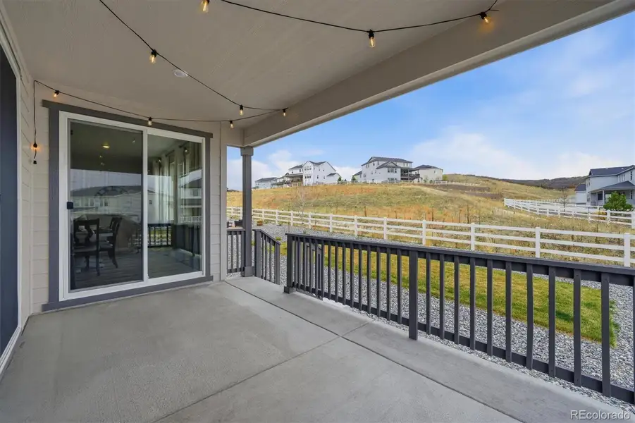 Covered back patio over looking the open space behind the property.