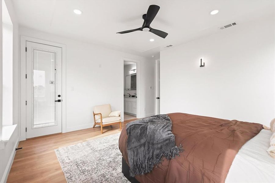 Bedroom with light wood-type flooring, recessed lighting, a ceiling fan, and ensuite bath Bedroom with light wood-type flooring, recessed lighting, a ceiling fan, and ensuite bath