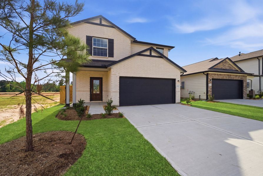 Front exterior of a new home in The Pines at Seven Coves, Willis, TX, highlighting curb appeal (Image 2).