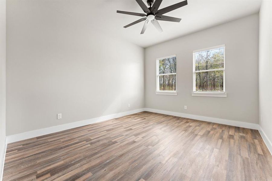 Unfurnished room featuring hardwood / wood-style flooring and ceiling fan