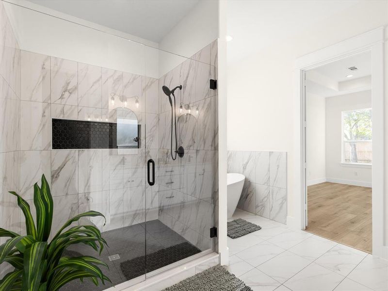 Full bath featuring a marble finish shower, light marble finish flooring, and a soaking tub