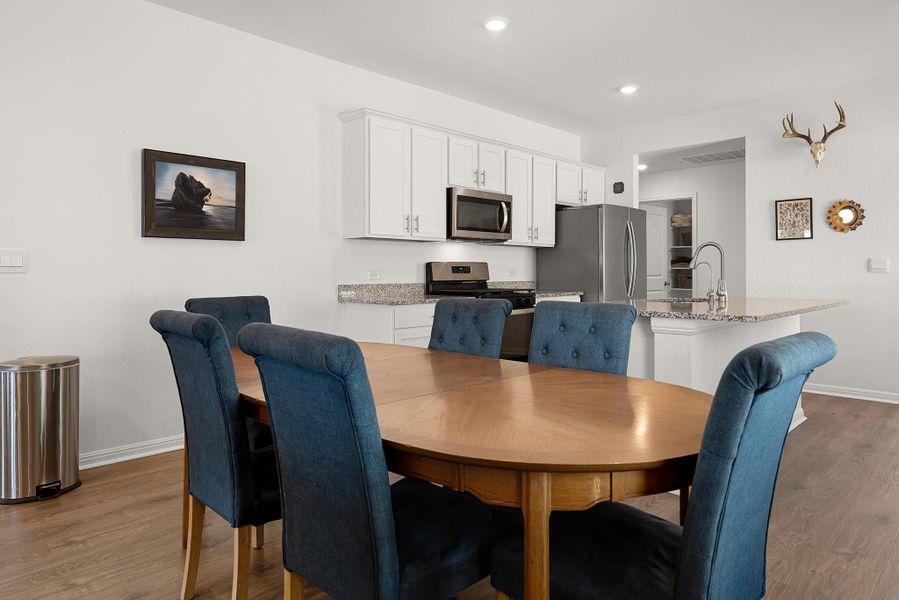 Dining room featuring dark wood-style floors and recessed lighting