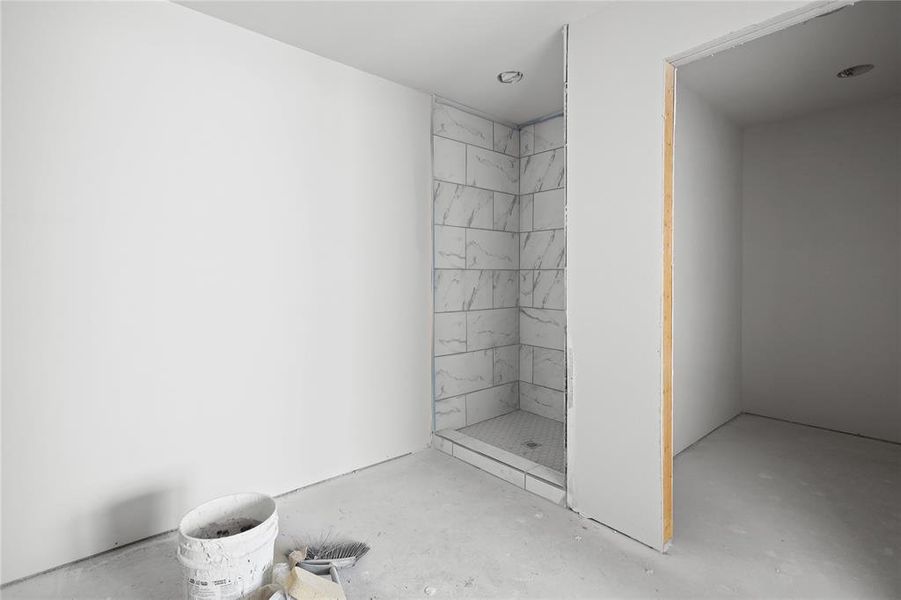 This space features a shower enclosure with tiled walls and a tiled floor