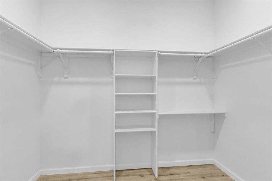 Walk in closet featuring light wood-type flooring