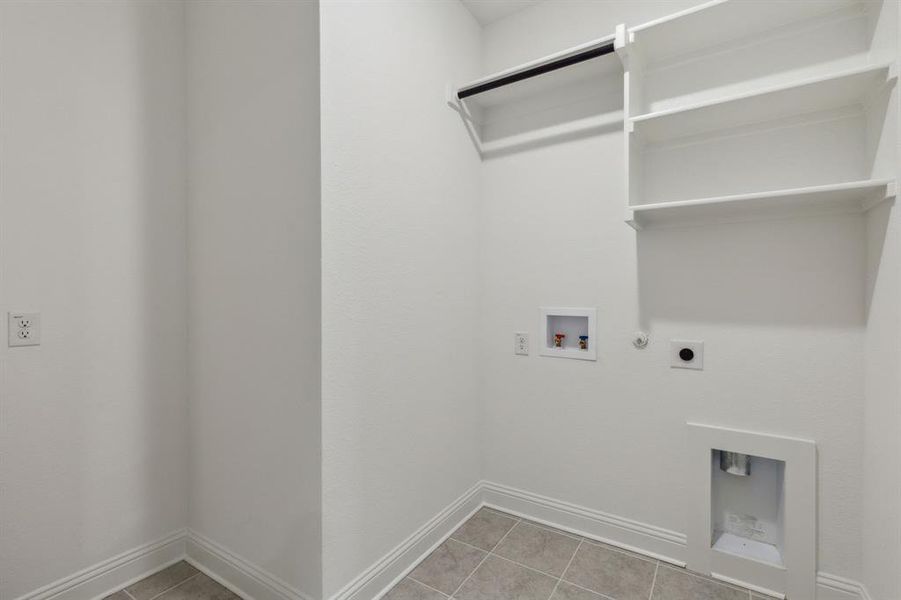 Laundry room with hookup for an electric dryer, hookup for a washing machine, tile patterned flooring, and gas dryer hookup