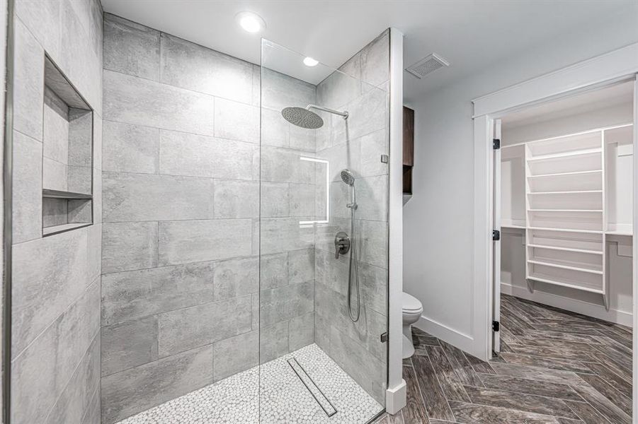 Full bath with walk in shower, a spacious closet, and recessed lighting Full bath with walk in shower, a spacious closet, and recessed lighting
