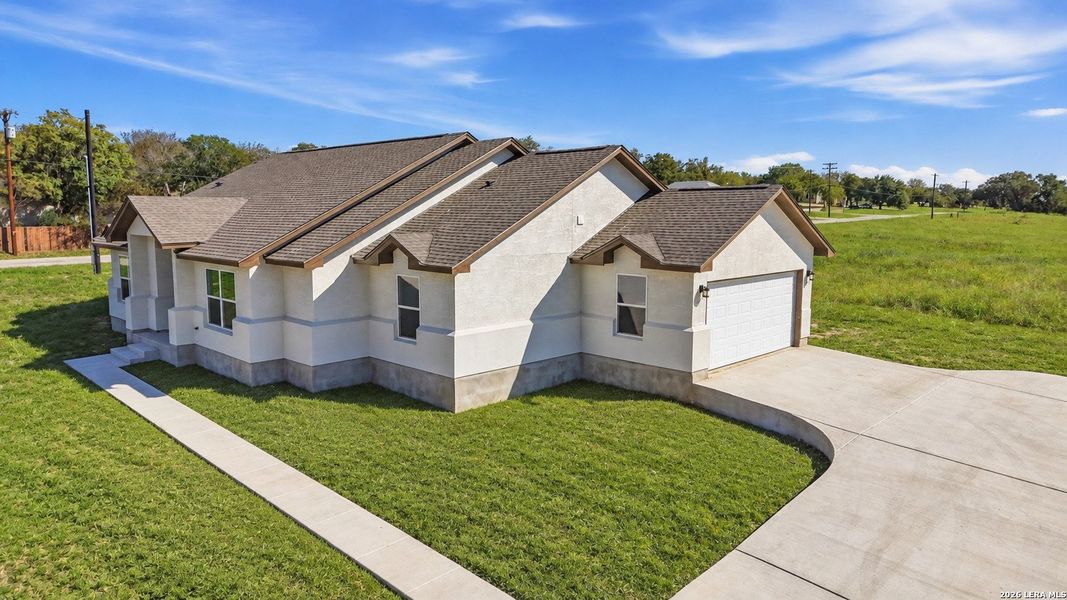 Front exterior of a new home in , Poteet, TX, highlighting curb appeal (Image 26).