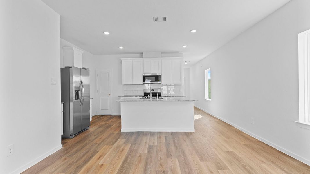 Furnished interior view inside a new home in Caldwell Crossing, Iowa Colony (Image 6).