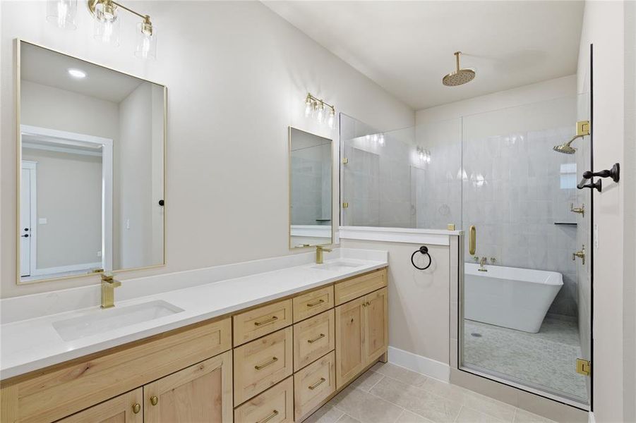 Double vanity with light wood cabinetry and white countertops