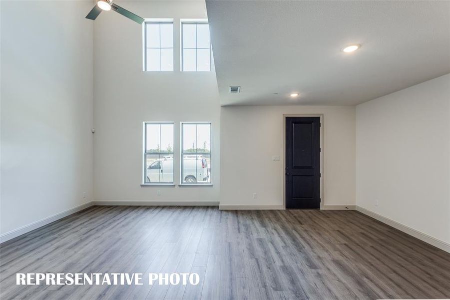 Featuring volume windows in the family room, this beautiful home is filled with natural light.  REPRESENTATIVE PHOTO