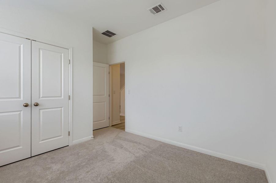 Unfurnished bedroom featuring carpet flooring and a closet Unfurnished bedroom featuring carpet flooring and a closet