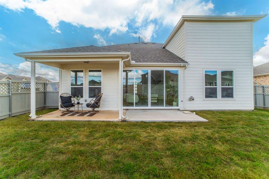 Back of property featuring a patio, a fenced backyard, and a shingled roof Back of property featuring a patio, a fenced backyard, and a shingled roof