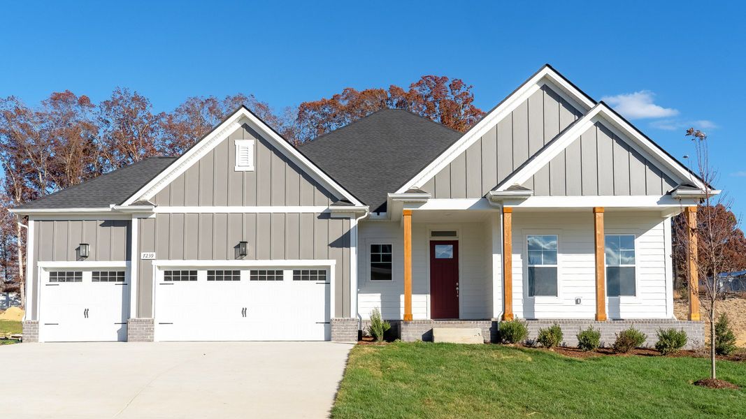 Exterior of single-story home with 3-car garage and covered front porch