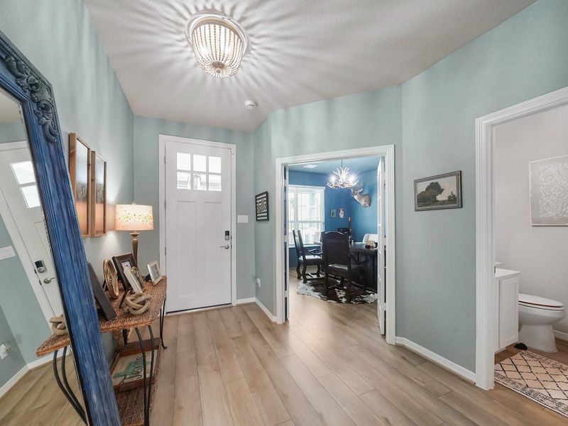 A versatile office space sits just off the entry, paired with a conveniently located half bath—ideal for working from home or accommodating guests.