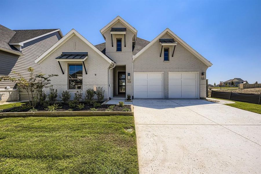 View of front of property with brick siding, concrete driveway, and a front yard View of front of property with brick siding, concrete driveway, and a front yard