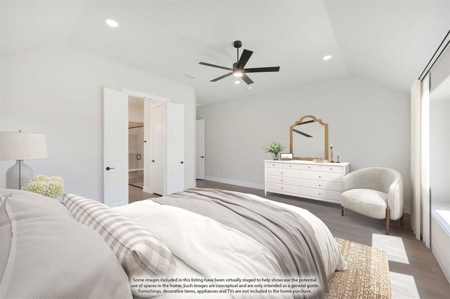 Master bedroom with vaulted ceiling, ceiling fan, white dresser, and doorway leading to ensuite bathroom and walk-in closet.