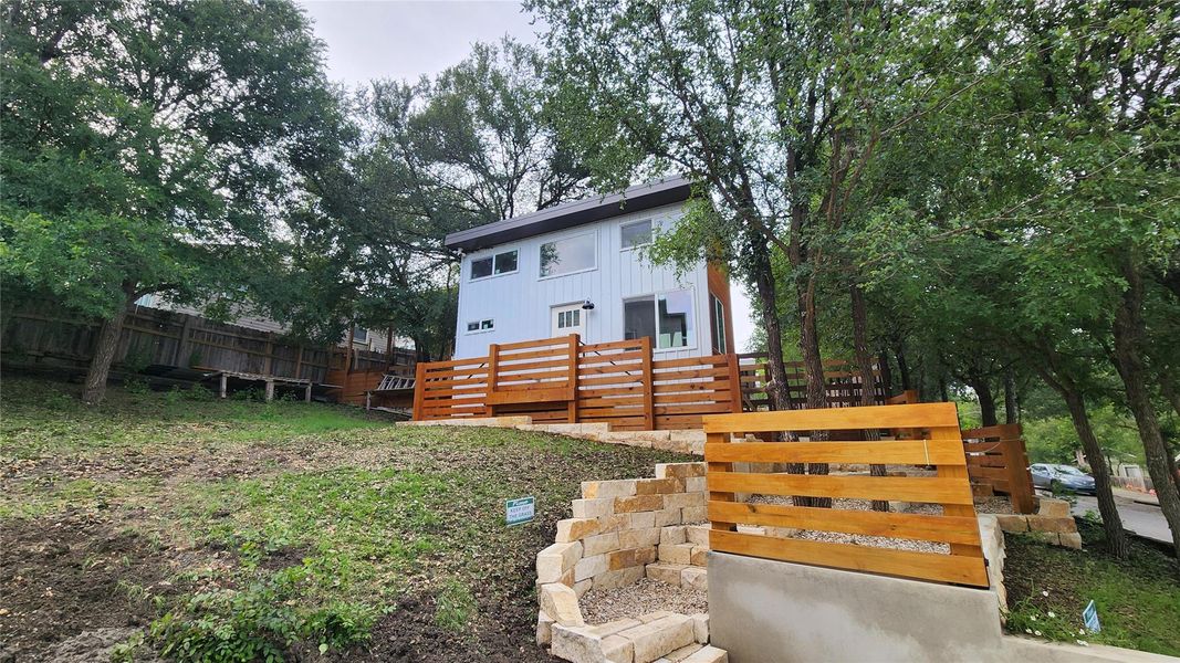 Front view of tiny home and entrance from driveway. Front view of tiny home and entrance from driveway.
