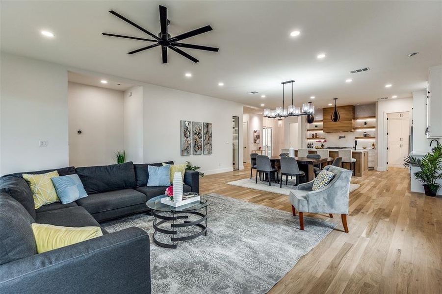 Living room featuring ceiling fan and light wood-type flooring