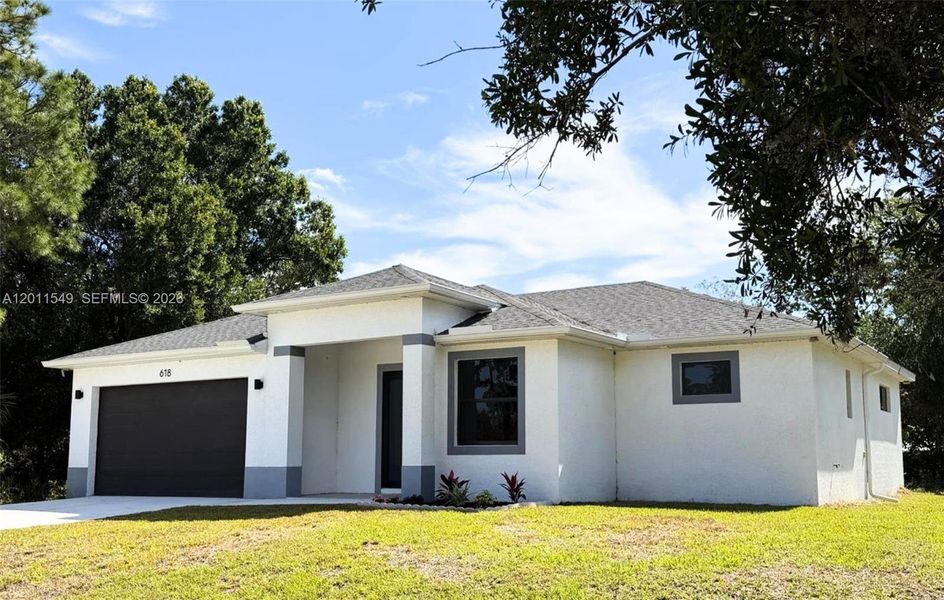 Front exterior of a new home in , Lehigh Acres, FL, highlighting curb appeal (Image 2). Front exterior of a new home in , Lehigh Acres, FL, highlighting curb appeal (Image 2).
