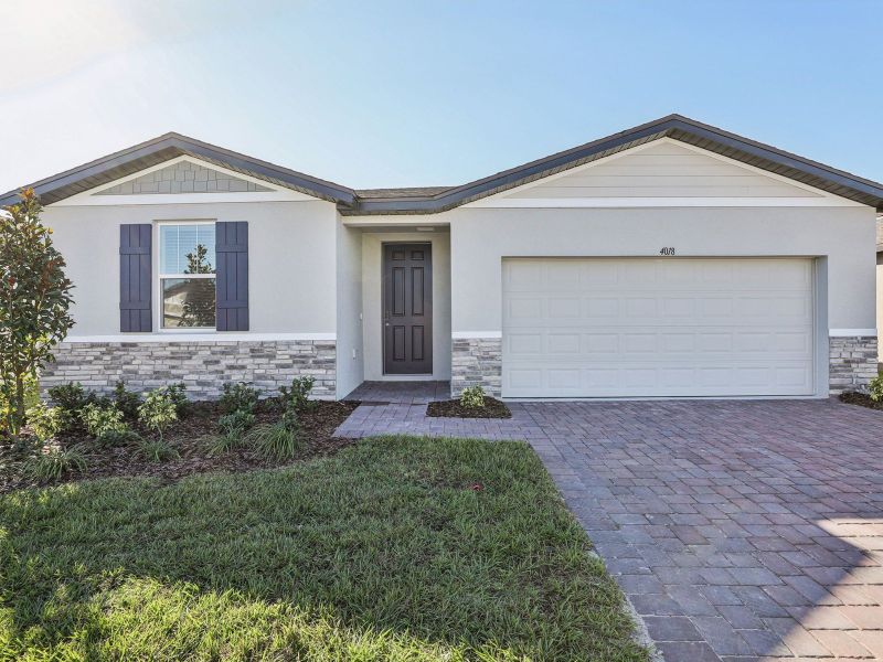 Front exterior of a new home in Lake Deer Estates - Signature Series, Poinciana, FL, highlighting curb appeal (Image 1).
