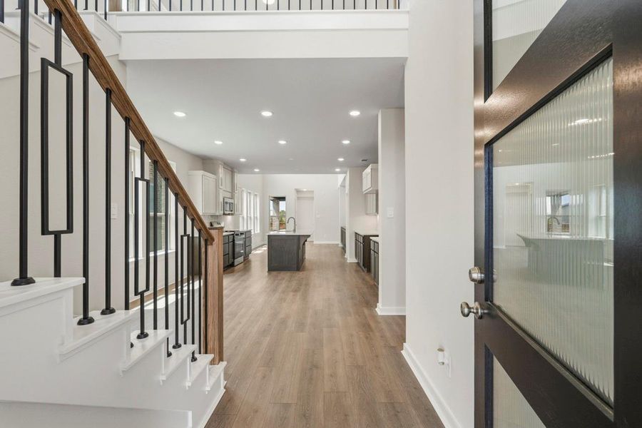The grand entryway makes a striking first impression with its elegant staircase, soaring ceilings, and welcoming sense of space.