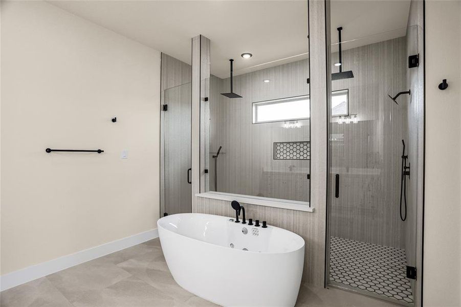 Bathroom with a shower stall and a freestanding tub Bathroom with a shower stall and a freestanding tub
