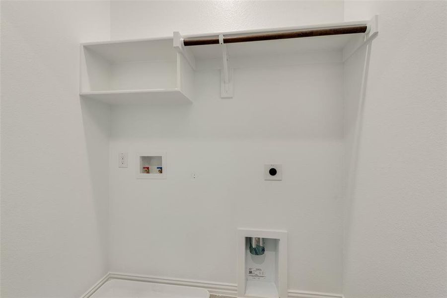 Washroom with electric dryer hookup, washer hookup, and hookup for a gas dryer