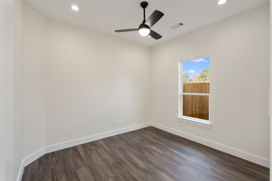 Empty room with recessed lighting, dark wood-style flooring, and a ceiling fan Empty room with recessed lighting, dark wood-style flooring, and a ceiling fan