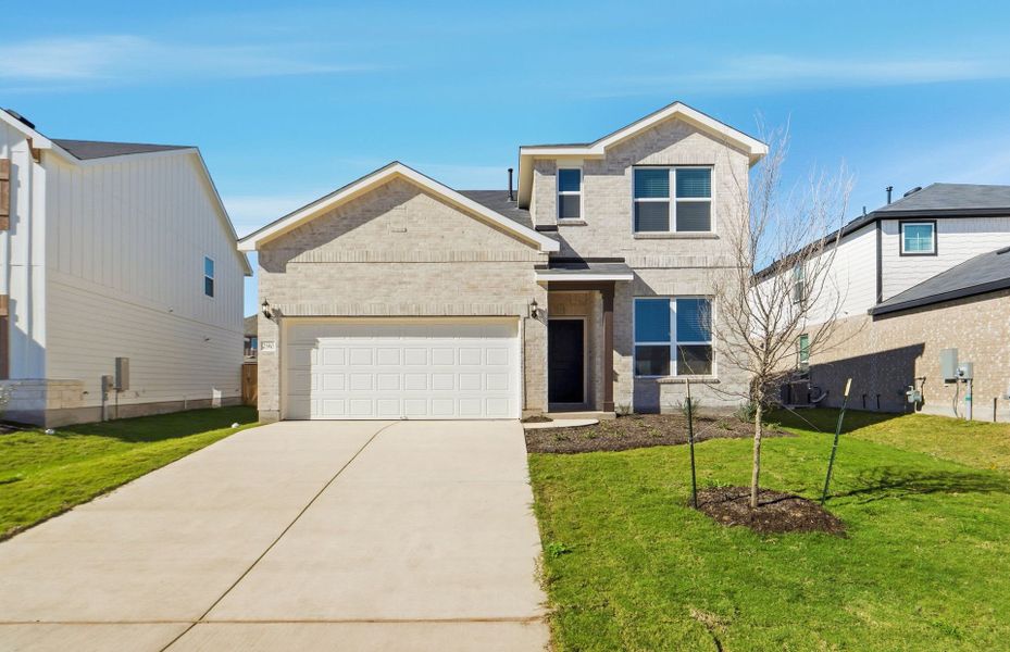 Front exterior of a new home in Sunfield, Buda, TX, highlighting curb appeal (Image 21). Front exterior of a new home in Sunfield, Buda, TX, highlighting curb appeal (Image 21).