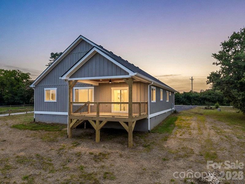 Twilight view of the back of the home, covered rear porch with fan, great entertainment floor plan and useable flat outdoor space Twilight view of the back of the home, covered rear porch with fan, great entertainment floor plan and useable flat outdoor space