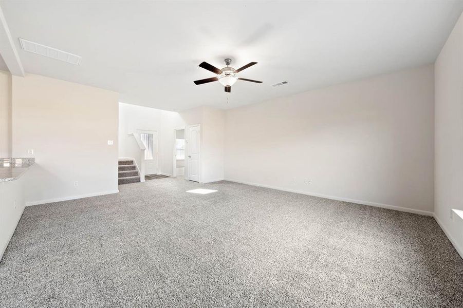 Unfurnished room with ceiling fan and carpet flooring