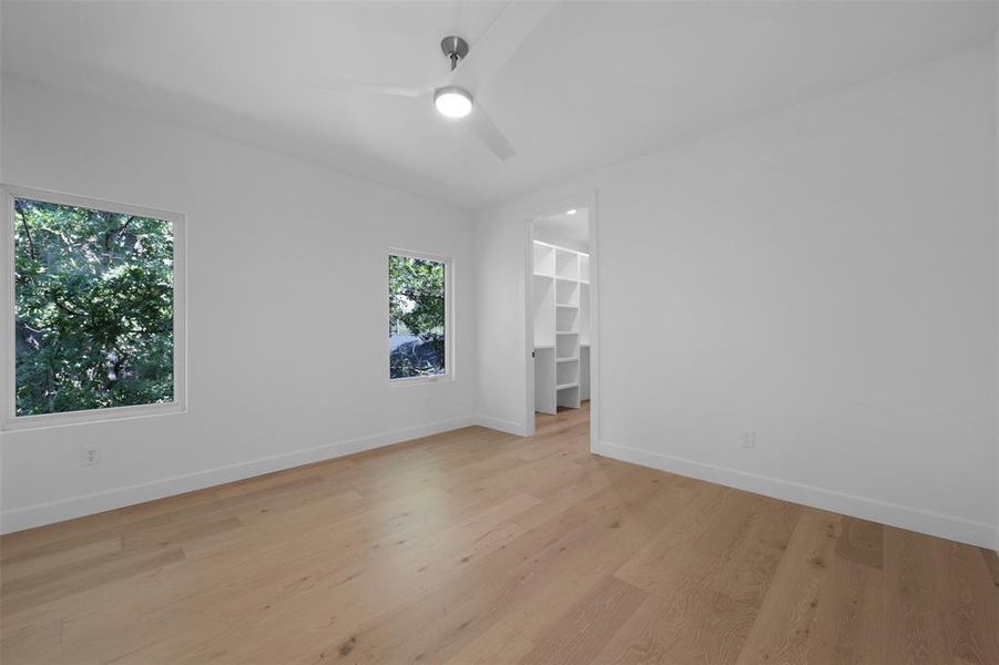 Spare room with light wood-style floors and ceiling fan