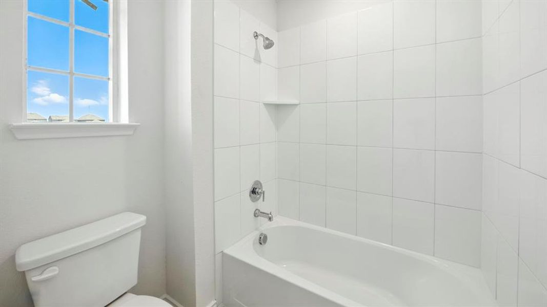 Bathroom featuring  shower combination and toilet