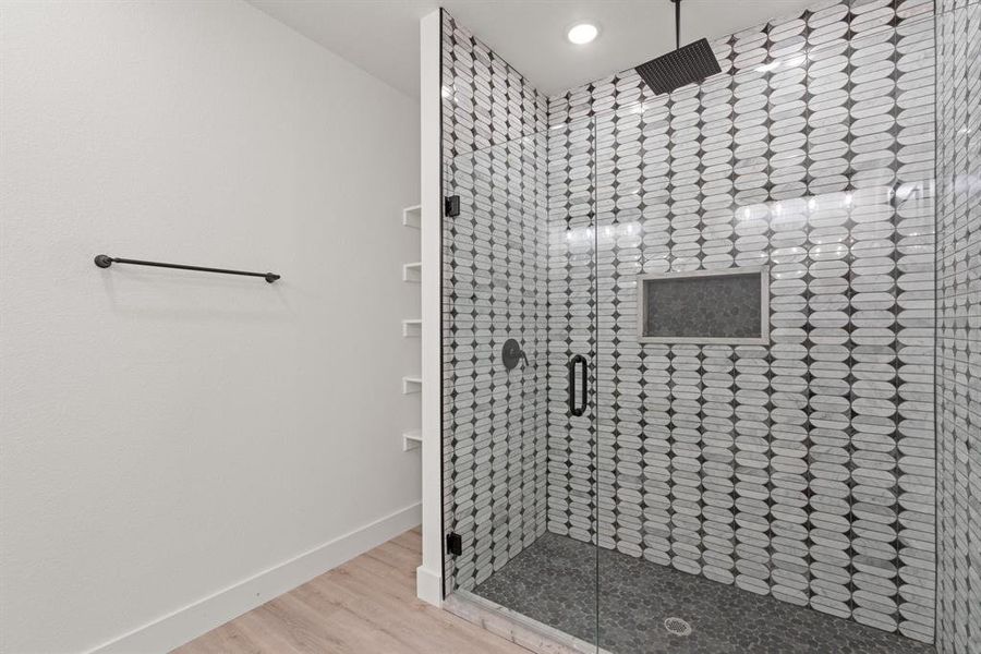 Bathroom featuring an enclosed shower and hardwood / wood-style flooring