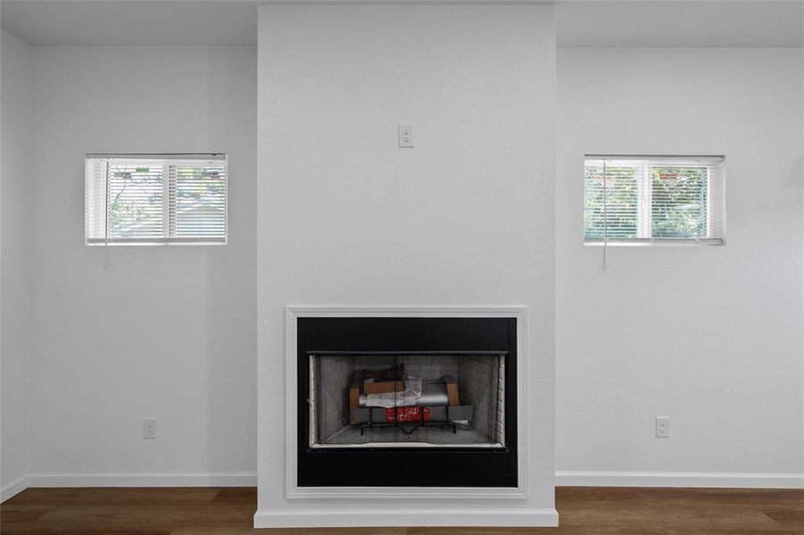 Central fireplace with a black surround and white trim Central fireplace with a black surround and white trim