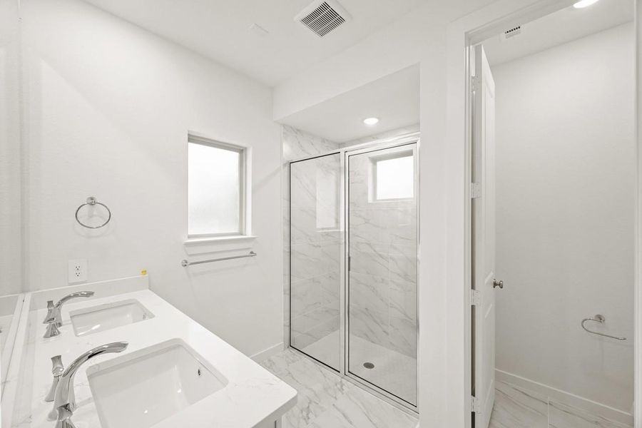 The primary bathroom offers a bright and airy space with a modern shower and a window that lets in natural light. The primary bathroom offers a bright and airy space with a modern shower and a window that lets in natural light.