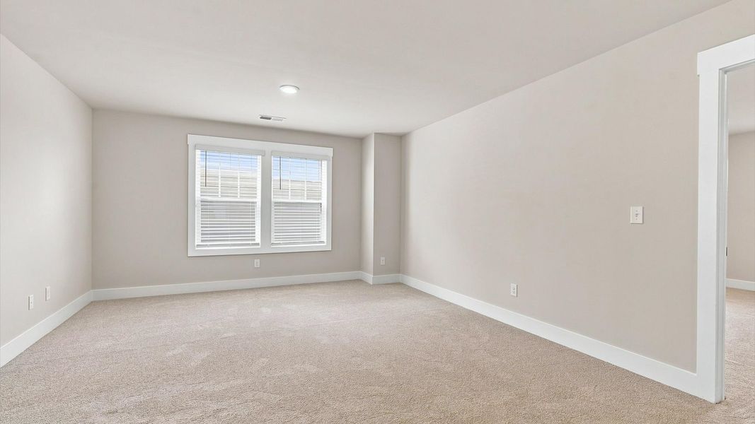 Vibrant loft with carpet flooring and flexible space for work, play, or relaxing located in Inman, SC
